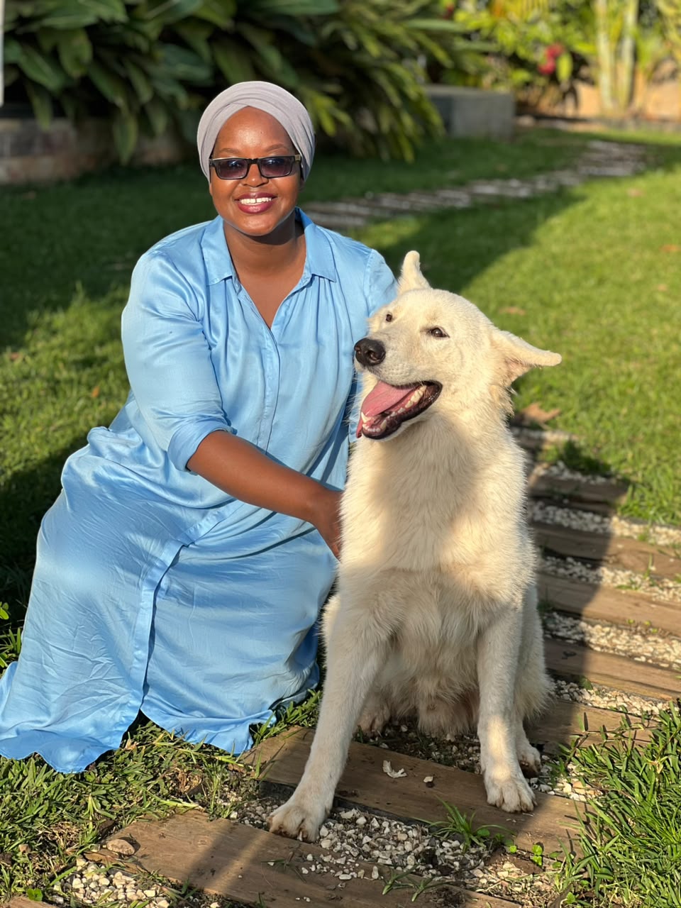 Client with her trained White Swiss Shepherd in the garden